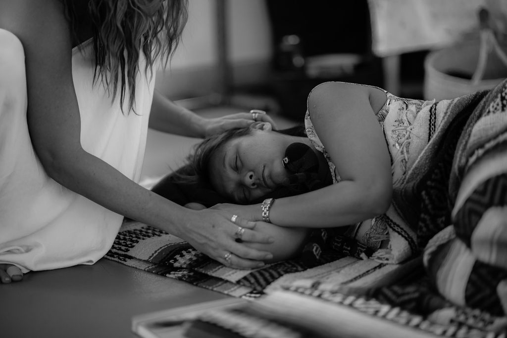 Jenna guiding a private session with a woman resting on the floor